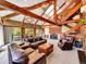 Large living room with vaulted ceilings, exposed beams, and floor-to-ceiling windows showcasing a stunning view at 24354 Eagle Cliff Trl, Conifer, CO 80433