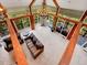 Open living room featuring vaulted ceilings, wooden beams, and sliding glass doors to large patio space at 24354 Eagle Cliff Trl, Conifer, CO 80433