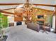Bright and spacious living room boasting wood beams, a grand fireplace, and elegant staircase at 24354 Eagle Cliff Trl, Conifer, CO 80433