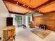 Spacious living room with exposed beams, natural light, and wood paneling, offering a cozy and inviting atmosphere at 24354 Eagle Cliff Trl, Conifer, CO 80433