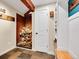 Mud room with slate flooring, storage and bench seating, offering a perfect blend of rustic charm and functionality at 24354 Eagle Cliff Trl, Conifer, CO 80433