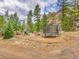 A fun play area, complete with a trampoline and play set, offers entertainment on this mountain property at 24354 Eagle Cliff Trl, Conifer, CO 80433
