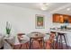 Charming dining area with a round table, stylish chairs, and a delightful coffee-themed art piece at 100 Park W Ave # 304, Denver, CO 80205