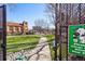 Beautiful green dog park with lush lawn, walking path, and lovely architectural building in the background at 100 Park W Ave # 304, Denver, CO 80205
