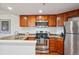 Cozy kitchen featuring stainless steel appliances, granite countertops, and ample cabinet space at 100 Park W Ave # 304, Denver, CO 80205
