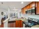 Open kitchen with stainless steel appliances and granite countertops that connects to the living room at 100 Park W Ave # 304, Denver, CO 80205