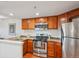 Modern kitchen featuring stainless steel appliances, granite countertops, and wooden cabinets at 100 Park W Ave # 304, Denver, CO 80205