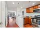 Open-concept kitchen with stainless steel appliances, granite countertops, and views into the living space at 100 Park W Ave # 304, Denver, CO 80205
