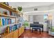 Bright living room with a piano, wooden floors, and built in bookshelves at 100 Park W Ave # 304, Denver, CO 80205