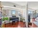 Living room featuring a piano and large windows with city views at 100 Park W Ave # 304, Denver, CO 80205