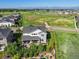 Wide shot shows house backing to a large green common area with mountain views in the distance at 1291 Fountain Ln, Erie, CO 80516