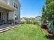 Well-manicured backyard with lush green lawn, mature landscaping, and a charming patio area at 1291 Fountain Ln, Erie, CO 80516