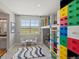 This colorful bedroom has bunk beds, a climbing wall, and a view of a green field at 1291 Fountain Ln, Erie, CO 80516