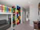This bedroom has a colorful climbing wall next to the bunk beds at 1291 Fountain Ln, Erie, CO 80516