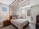 Cozy bedroom featuring a patterned ceiling, side tables with lamps, and soft carpet at 1291 Fountain Ln, Erie, CO 80516