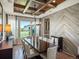 Elegant dining room with coffered ceiling, modern chandelier, and stylish herringbone accent wall at 1291 Fountain Ln, Erie, CO 80516