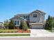 Charming two-story home featuring a well-manicured lawn, attractive landscaping, and elegant stone accents at 1291 Fountain Ln, Erie, CO 80516