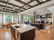 Open-concept kitchen and living room featuring a kitchen island, a dining table, and a cozy living area at 1291 Fountain Ln, Erie, CO 80516