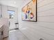 This modern laundry room has bright white walls, a large painting, and great natural light at 1291 Fountain Ln, Erie, CO 80516