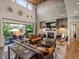 Bright, open living room featuring a fireplace, high ceilings, and leather furniture opening to the outdoor area at 1291 Fountain Ln, Erie, CO 80516