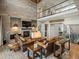 Living room showcasing fireplace, high ceilings, leather sofas, and hardwood floors at 1291 Fountain Ln, Erie, CO 80516