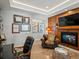 Cozy office space featuring a fireplace, wood paneling, and built-in bookshelves at 1291 Fountain Ln, Erie, CO 80516
