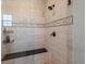 Modern shower design featuring accent tile, a built-in bench and glass enclosure at 1291 Fountain Ln, Erie, CO 80516