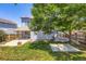 Wide backyard with grass, a small patio, a wood fence, and the rear of the home with siding at 13265 Raritan St, Denver, CO 80234