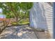 Concrete patio shaded by a large tree with a wood fence and grass in the backyard at 13265 Raritan St, Denver, CO 80234