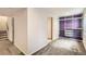 Finished basement featuring neutral carpet, white walls, and a custom closet with purple backing at 13265 Raritan St, Denver, CO 80234