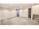 Spacious basement with gray carpet, recessed lighting, and a dark gray door leading to the stairway at 13265 Raritan St, Denver, CO 80234