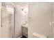 Compact bathroom featuring a stand-up shower, vanity with storage, and neutral-toned walls at 13265 Raritan St, Denver, CO 80234