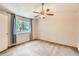 Bright bedroom featuring a ceiling fan, neutral walls, and large window at 13265 Raritan St, Denver, CO 80234