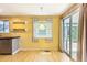 Bright dining area featuring access to backyard, window views, and modern lighting at 13265 Raritan St, Denver, CO 80234