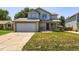 Charming two-story home with a well-maintained lawn and inviting front porch at 13265 Raritan St, Denver, CO 80234