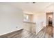 Bright upstairs hallway with modern light fixture and view into the bathroom at 13265 Raritan St, Denver, CO 80234