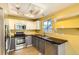 Contemporary kitchen featuring stainless steel appliances, dark countertops, and light cabinetry at 13265 Raritan St, Denver, CO 80234