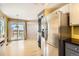 Kitchen showcasing stainless steel refrigerator, plenty of light, and access to backyard at 13265 Raritan St, Denver, CO 80234
