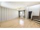 Open living room with wood floors, lots of light, and staircase to the upper level at 13265 Raritan St, Denver, CO 80234