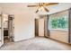 Bright main bedroom features a ceiling fan, large window, and an attached bath at 13265 Raritan St, Denver, CO 80234