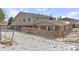 Fenced backyard and brick and siding exterior of a home during winter at 9886 Appletree Pl, Thornton, CO 80260