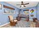 Vibrant bedroom with blue walls, carpet, large windows, and a loft bed with integrated desk space at 9886 Appletree Pl, Thornton, CO 80260