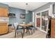 Cozy dining area with table, chairs, and sliding glass door, creating a warm and inviting space for meals at 9886 Appletree Pl, Thornton, CO 80260
