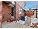 Charming brick home featuring a cozy entrance, with a fenced patio, and outdoor seating at 9886 Appletree Pl, Thornton, CO 80260