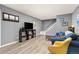 Bright living room with modern laminate flooring, stylish gray walls, and comfortable seating perfect for relaxing at 9886 Appletree Pl, Thornton, CO 80260