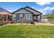 Green backyard lawn featuring well maintained landscaping and siding at 3429 Goodyear St, Castle Rock, CO 80109