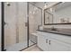 Bathroom featuring glass enclosed shower, modern fixtures, a mirror, stylish lighting, and vanity with black hardware at 3429 Goodyear St, Castle Rock, CO 80109