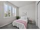 This bedroom features a plush carpet, neutral walls, and windows with white shutters that let in plenty of natural light at 3429 Goodyear St, Castle Rock, CO 80109