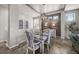 Elegant dining room with wood floors, stylish lighting, and seating for six at 3429 Goodyear St, Castle Rock, CO 80109
