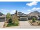 Charming home with a well-manicured front yard, stone chimney, and attached garage at 3429 Goodyear St, Castle Rock, CO 80109